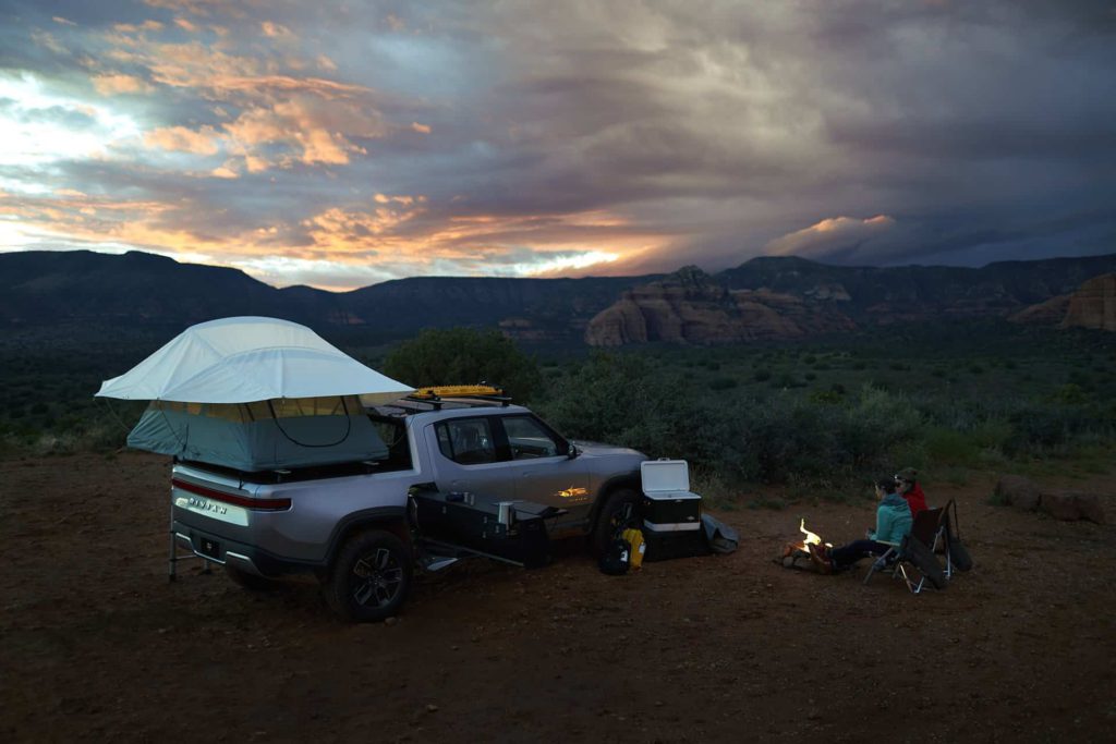 Off-Road Electric Rivian R1T Truck camp setup at sunset in Sedona Arizona